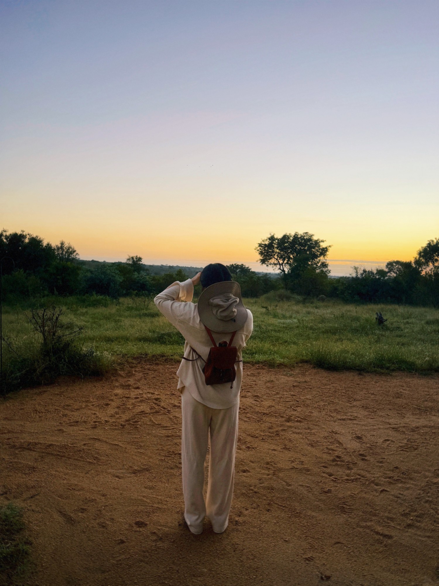 Tina watching a sunrise on safari