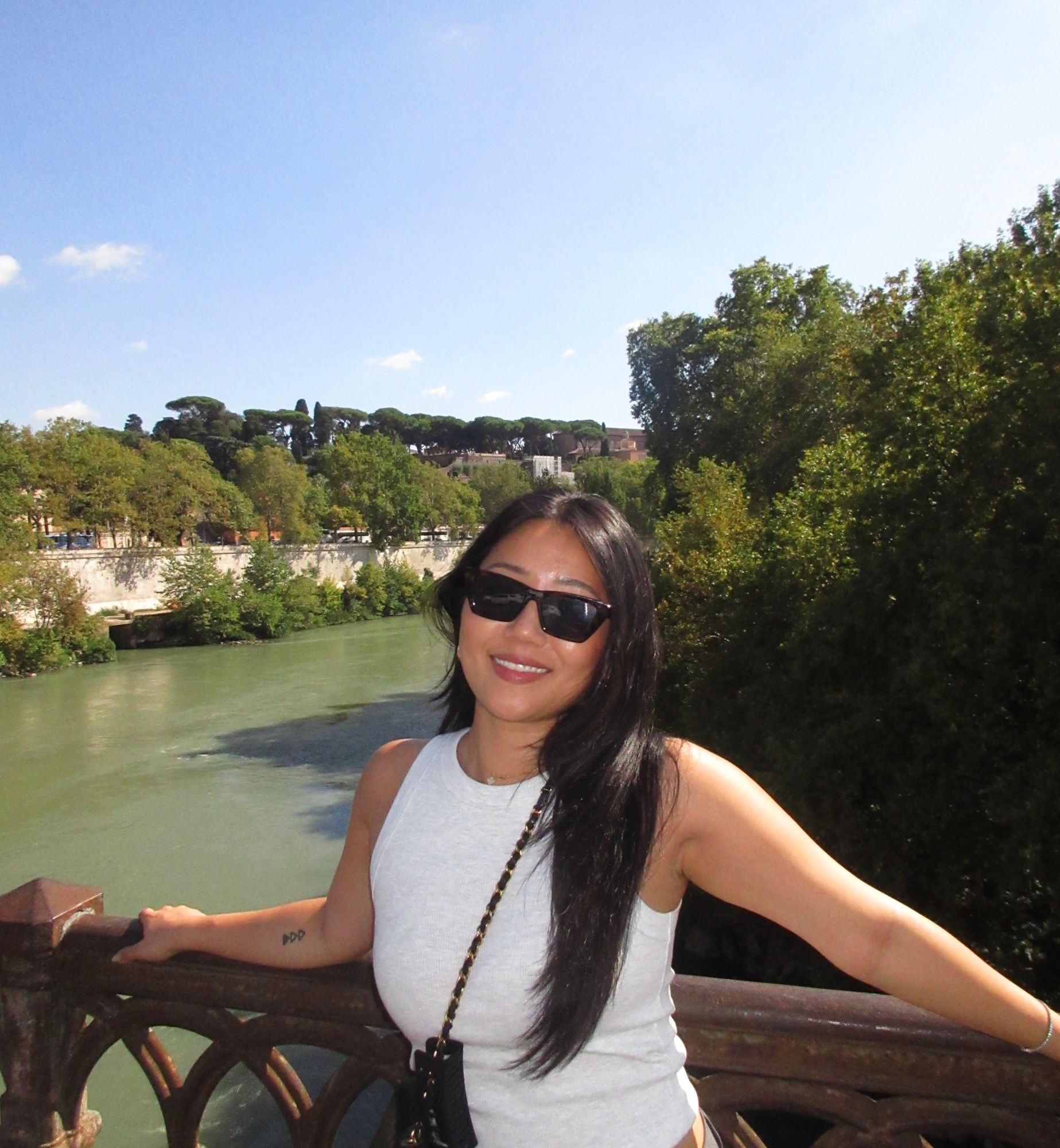 Tina smiling on a bridge in Rome